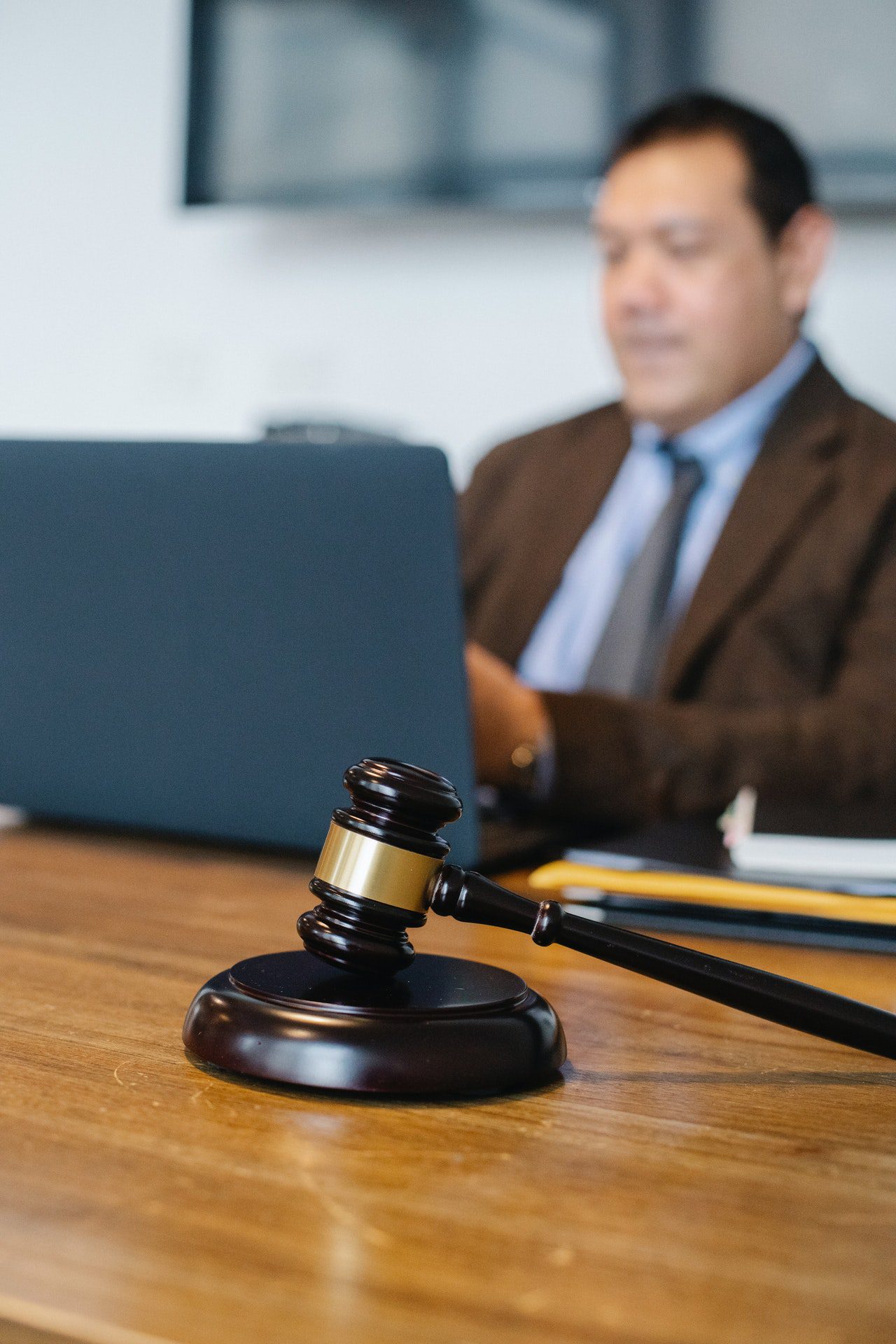 Male lawyer working on laptop in office